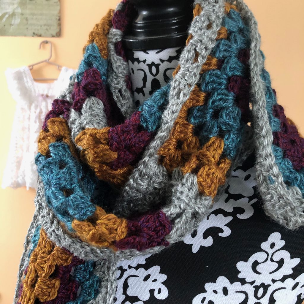 Heartland Granny Square Scarf | Crochet Pattern by MadameStitch  This scarf is the perfect fall accessory. Made with Lion Brand's Heartland worsted weight yarn, the 10 granny squares work up quickly. Skill level: Beginner #crochetscarf #scarfpattern #crochetpattern