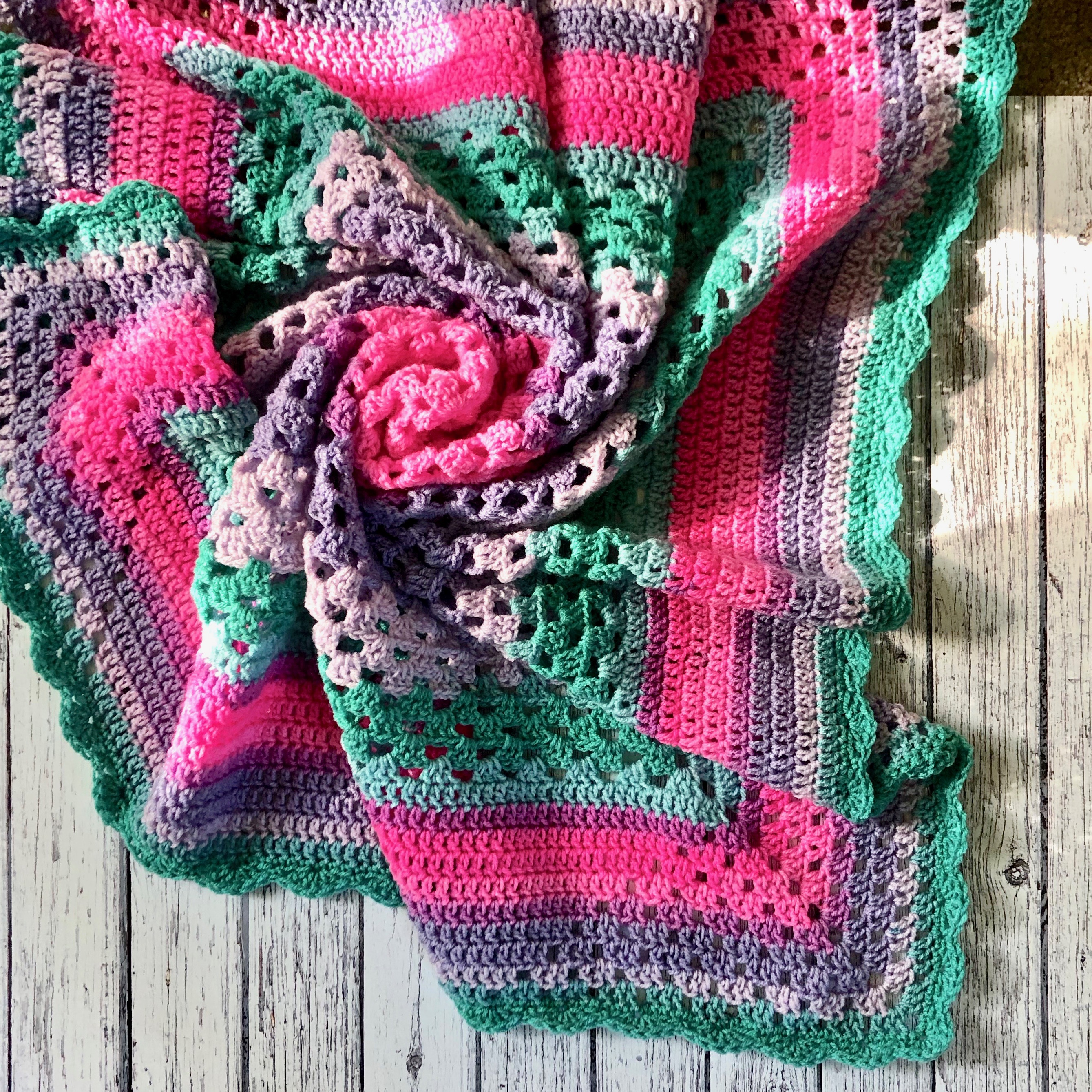 Flatlay on board of the diamond corner granny baby blanket