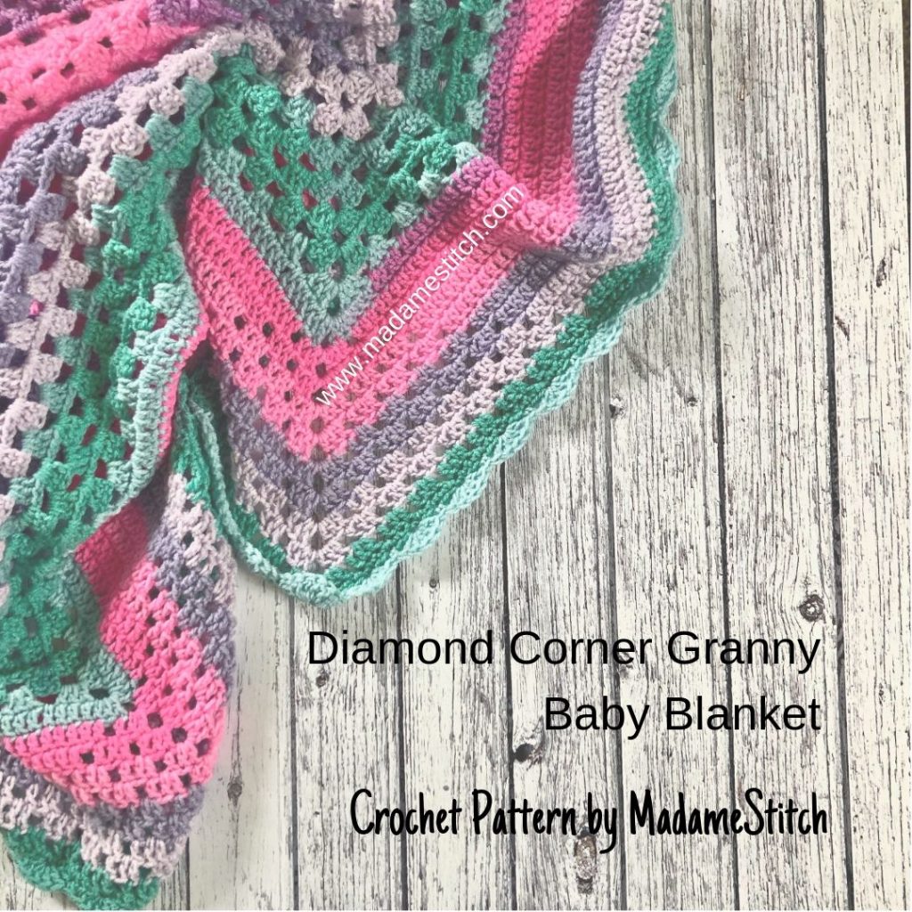 Diamond Corner Granny Baby Blanket | Crochet Pattern by MadameStitch The center #grannysquare section is followed by a solid section with a pattern of spaces that look like a diamond. #babyblanket #crochetpattern