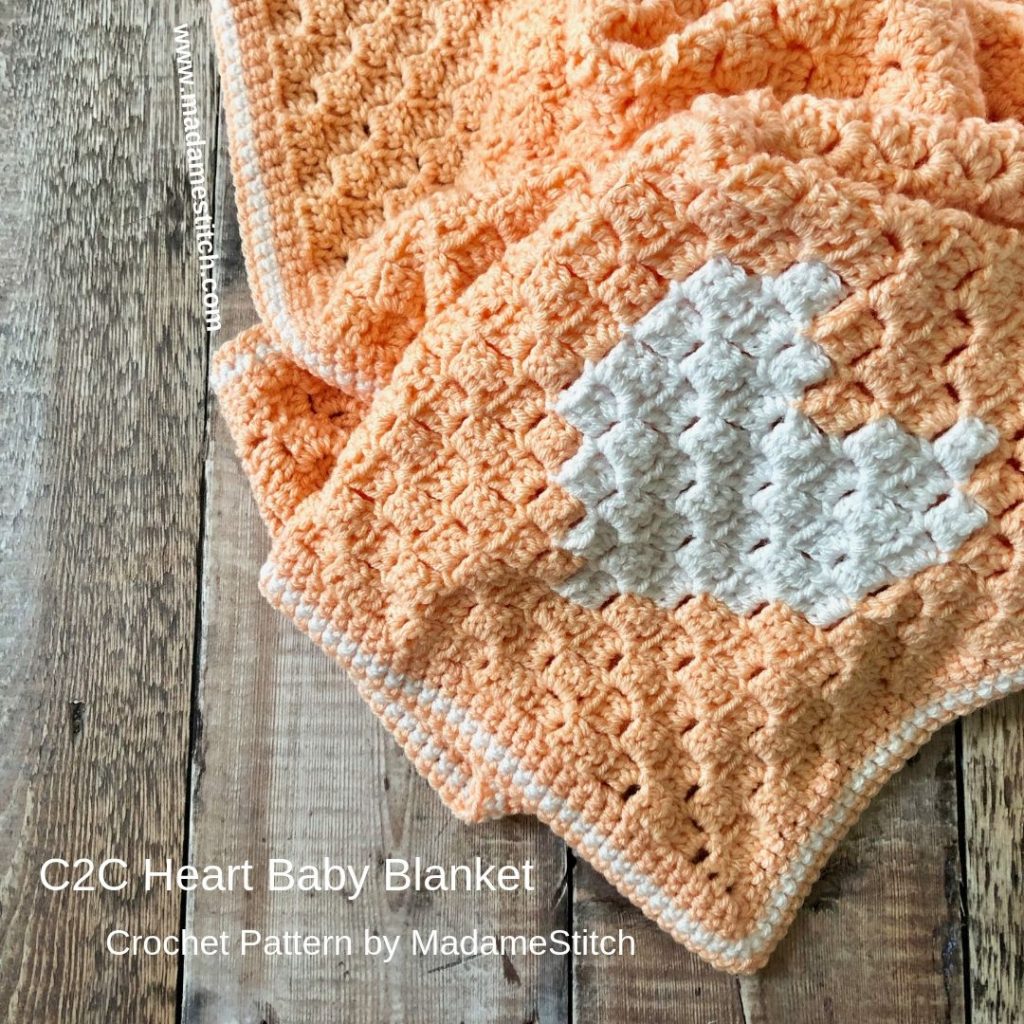 C2C Heart Baby Blanket | Crochet pattern by MadameStitch; An easy + quick corner to corner #crochet blanket for that special little one. The corner heart accent adds just the right touch. An adorable addition to any nursery. Skill level: Advanced beginner. #crochet #c2ccrochet #babyblanket #babyblanketpattern #crochetpattern