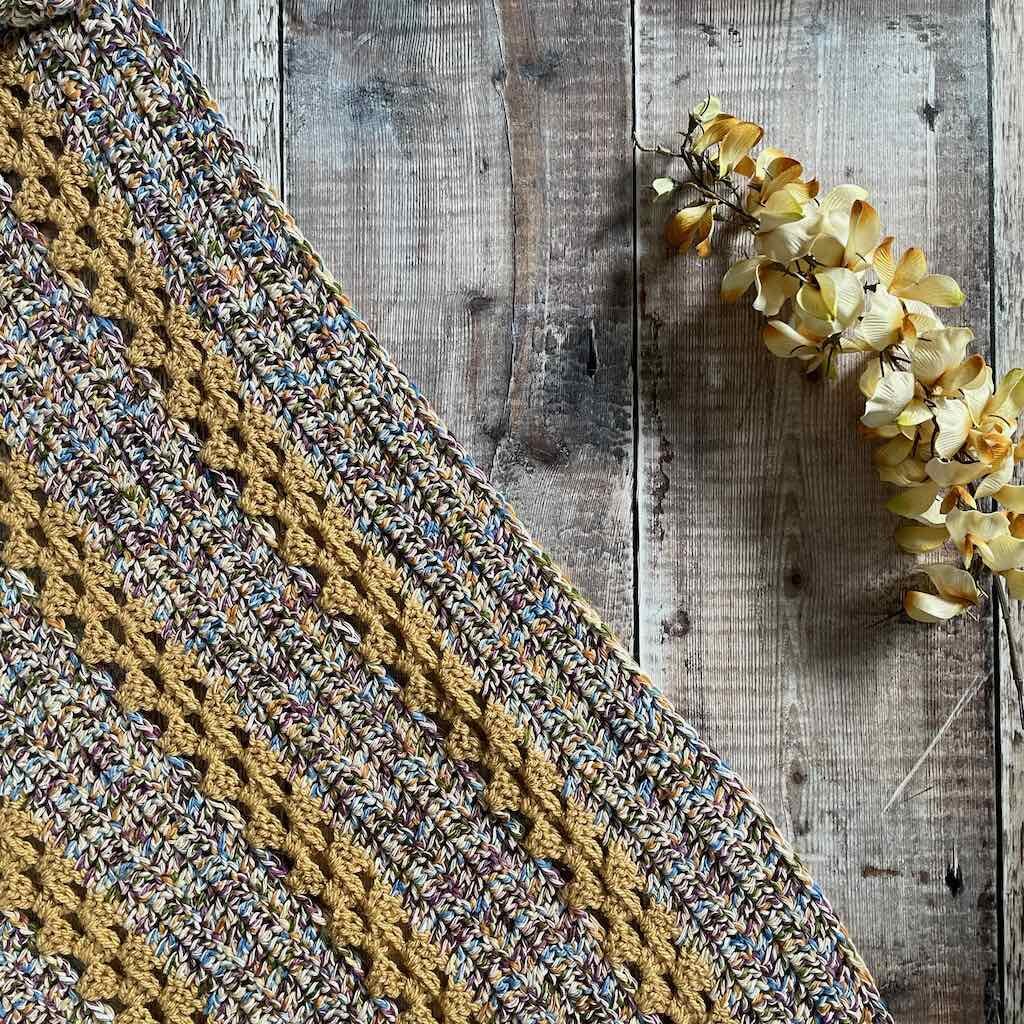 Flatlay of Library Book Shawl and flowers