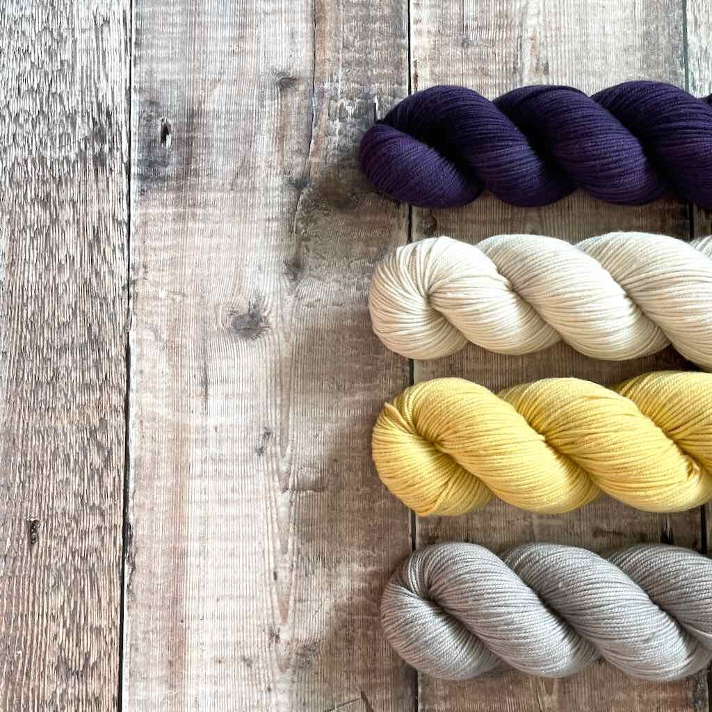 Miss Babs "Kaweah" yarn in purple, off-white, yellow and gray