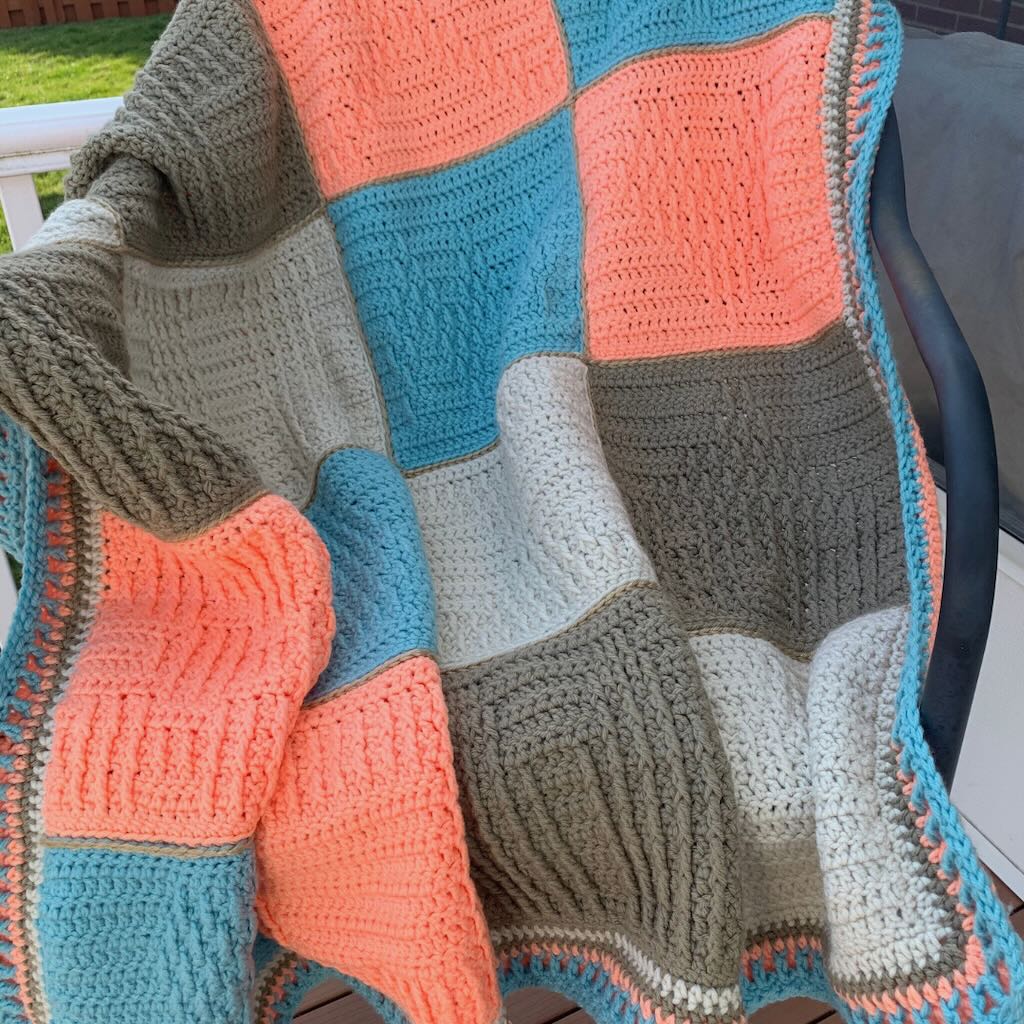 Here Comes Treble Blanket with crochet textured squares