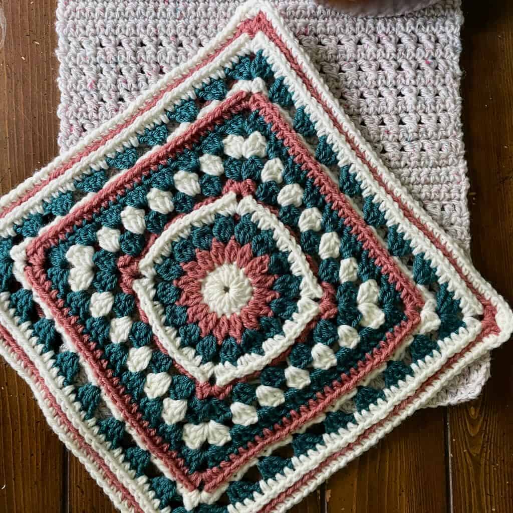 A granny stitch afghan square sitting on a table