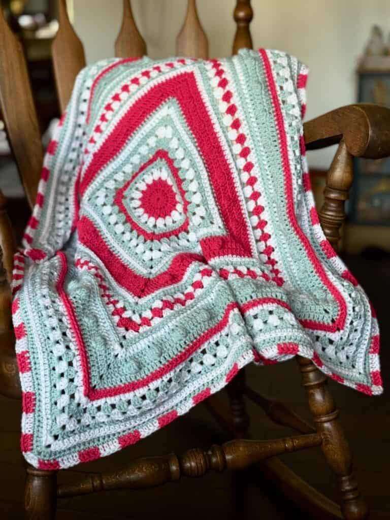 A photo of a Christmas crochet baby blanket | A free pattern by MadameStitch