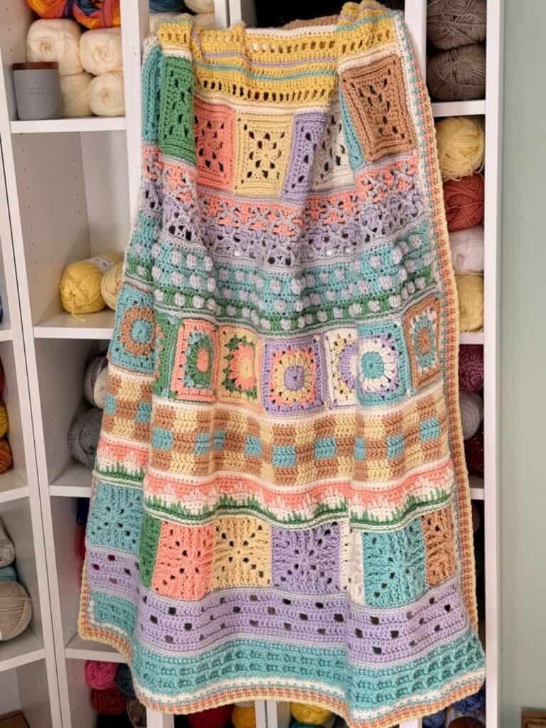 A photo of the crochet blanket hanging on a ladder