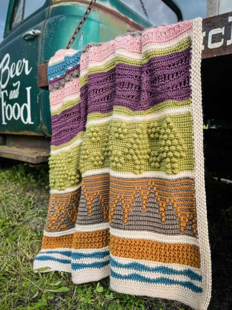 A photo of the Road Trip Blanket draped over an old truck