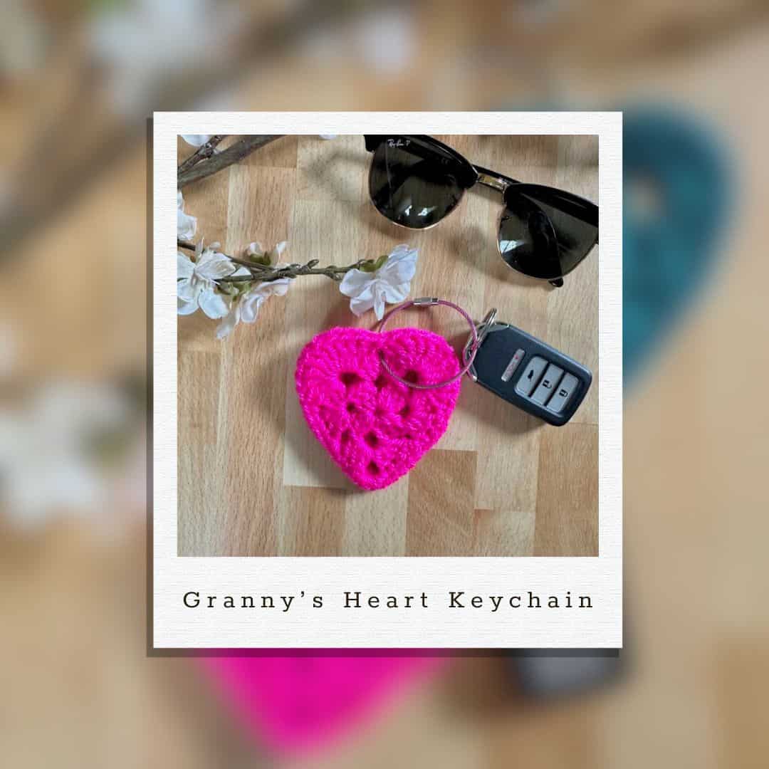 A photo of Granny's Crochet Heart Keychain with a pair of sunglasses