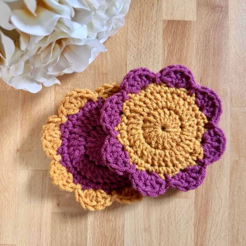 A photo of 2 Polka Dot Flower Coasters with a bouquet of flowers on wood