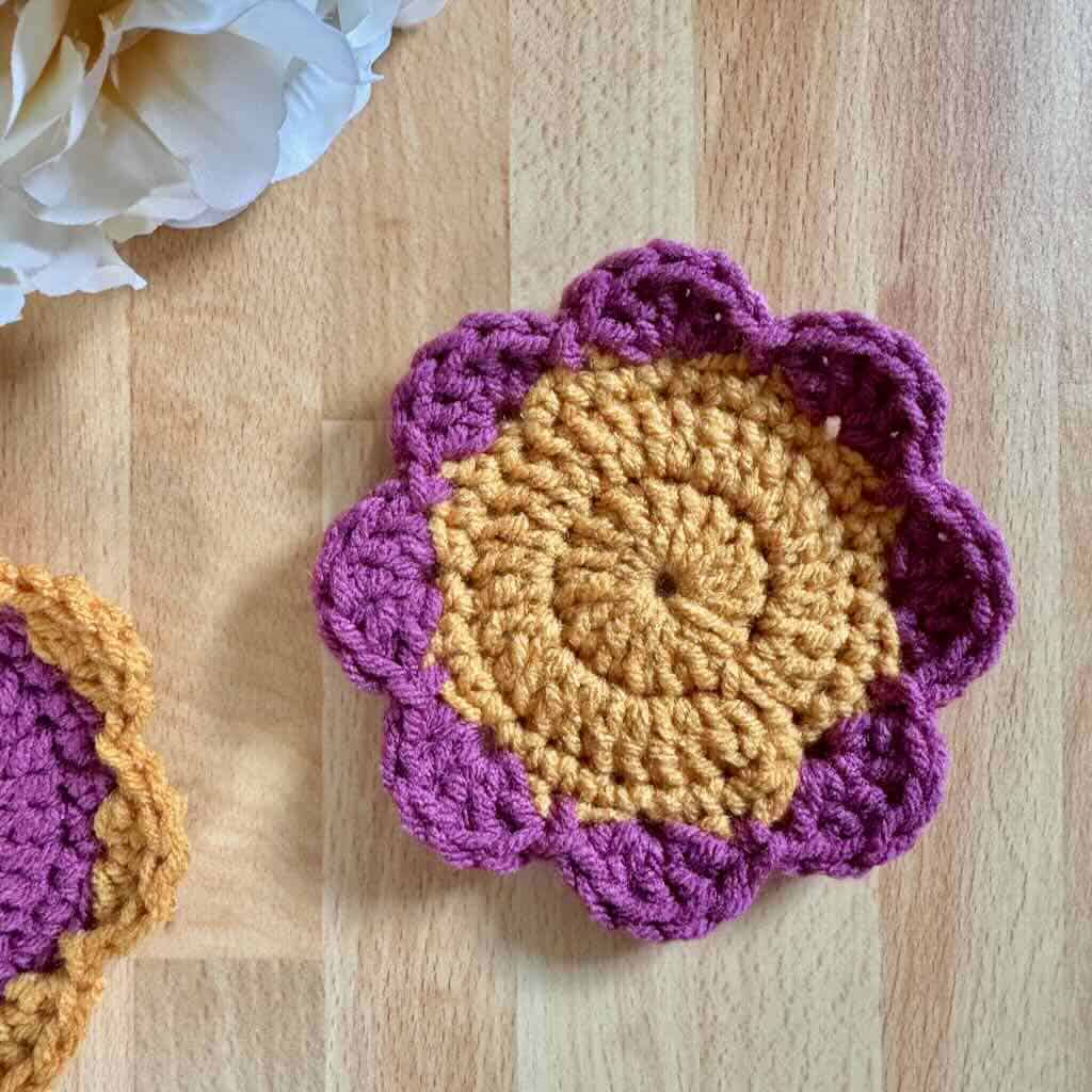 A photo of the Polka Dot Flower Coaster with a bouquet of flowers on a wood background