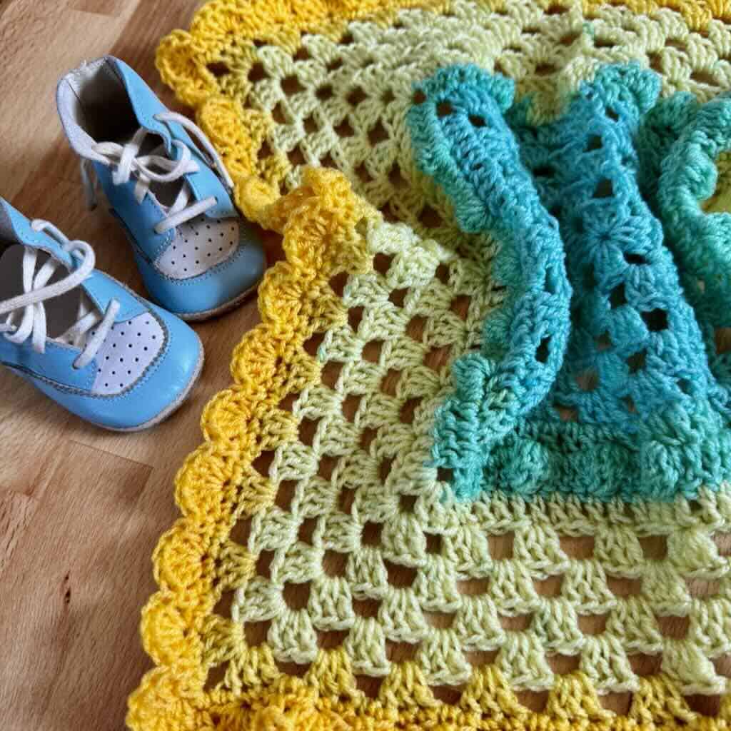 Photo of a preemie lovey blanket with baby shoes