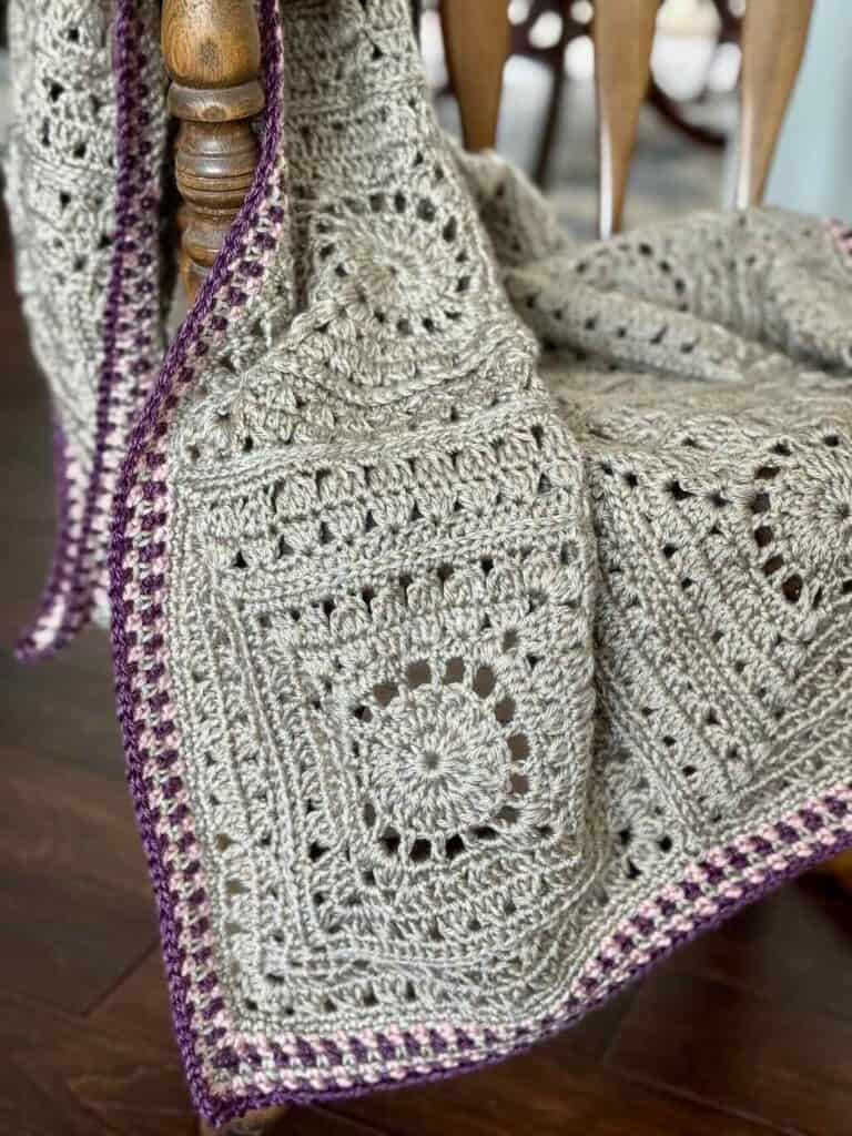 A photo of the granny square lap blanket on a rocking chair