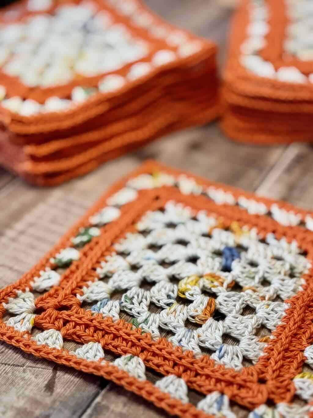 A photo of a stack of squares for the granny square baby blanket