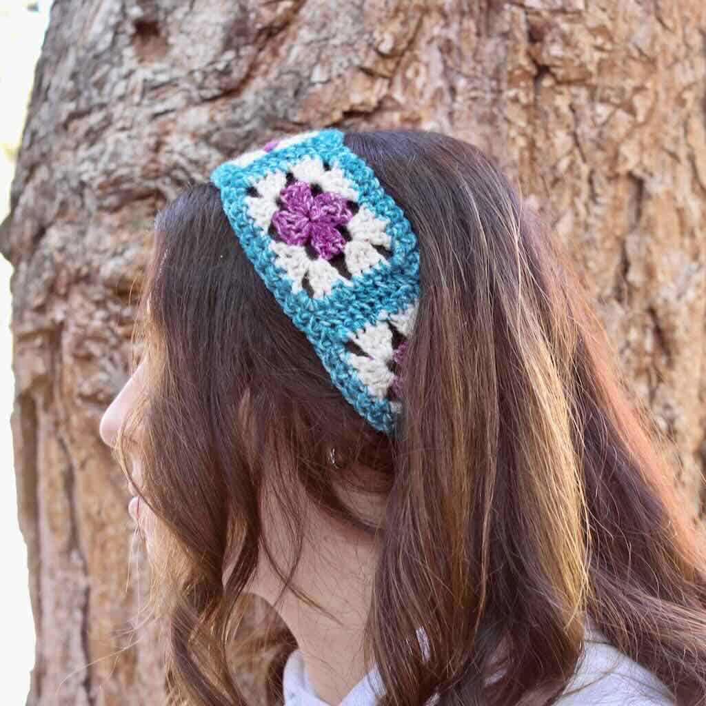 Crochet granny square headband worn by a college student in front of a tree