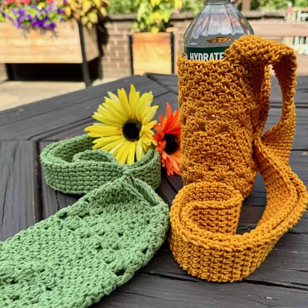A photo of a god water bottle holder and a green water bottle holder on the back patio